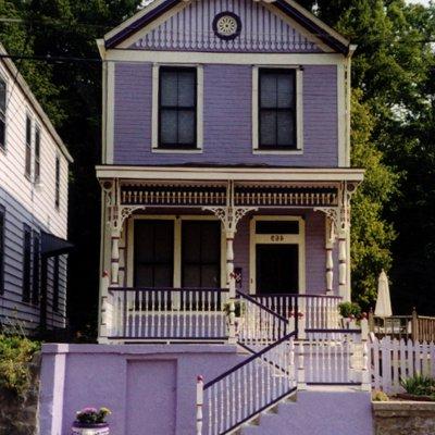 Purple Painted Lady Victorian home facade historic restoration  